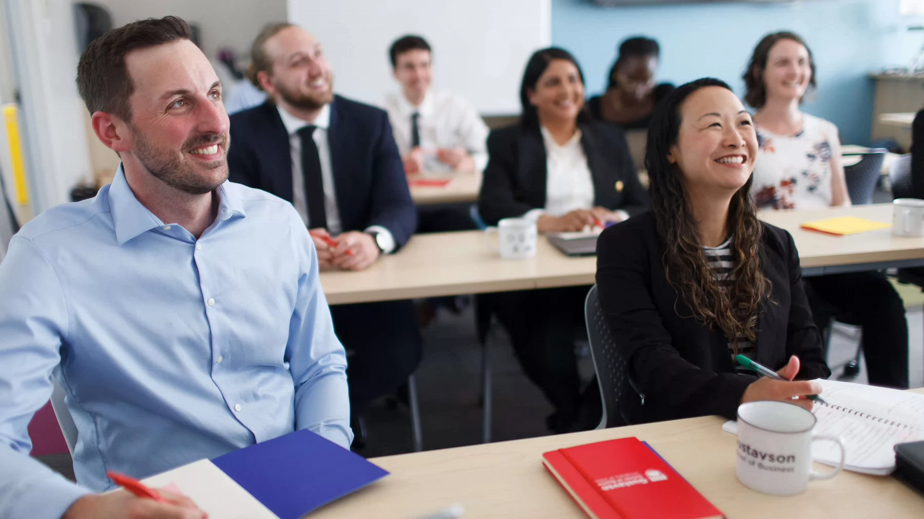 MBA students sitting at their desks during a lecture. Photo credit: Geoff Howe.